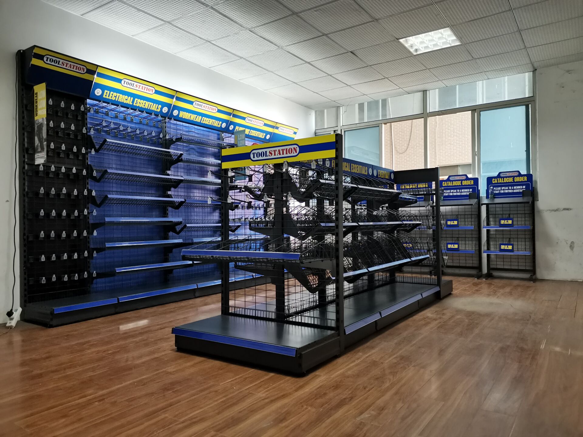 Tool display stand with a tool wall display in the background